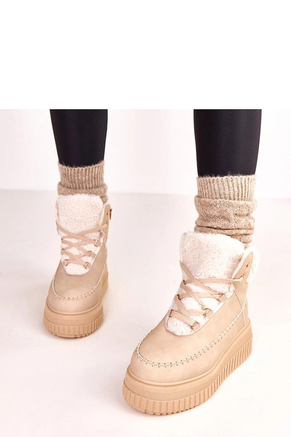 Close-up of Solea's sports ankle boots showcasing high-quality eco-leather, lacing details, and plush faux fur lining for luxury comfort.