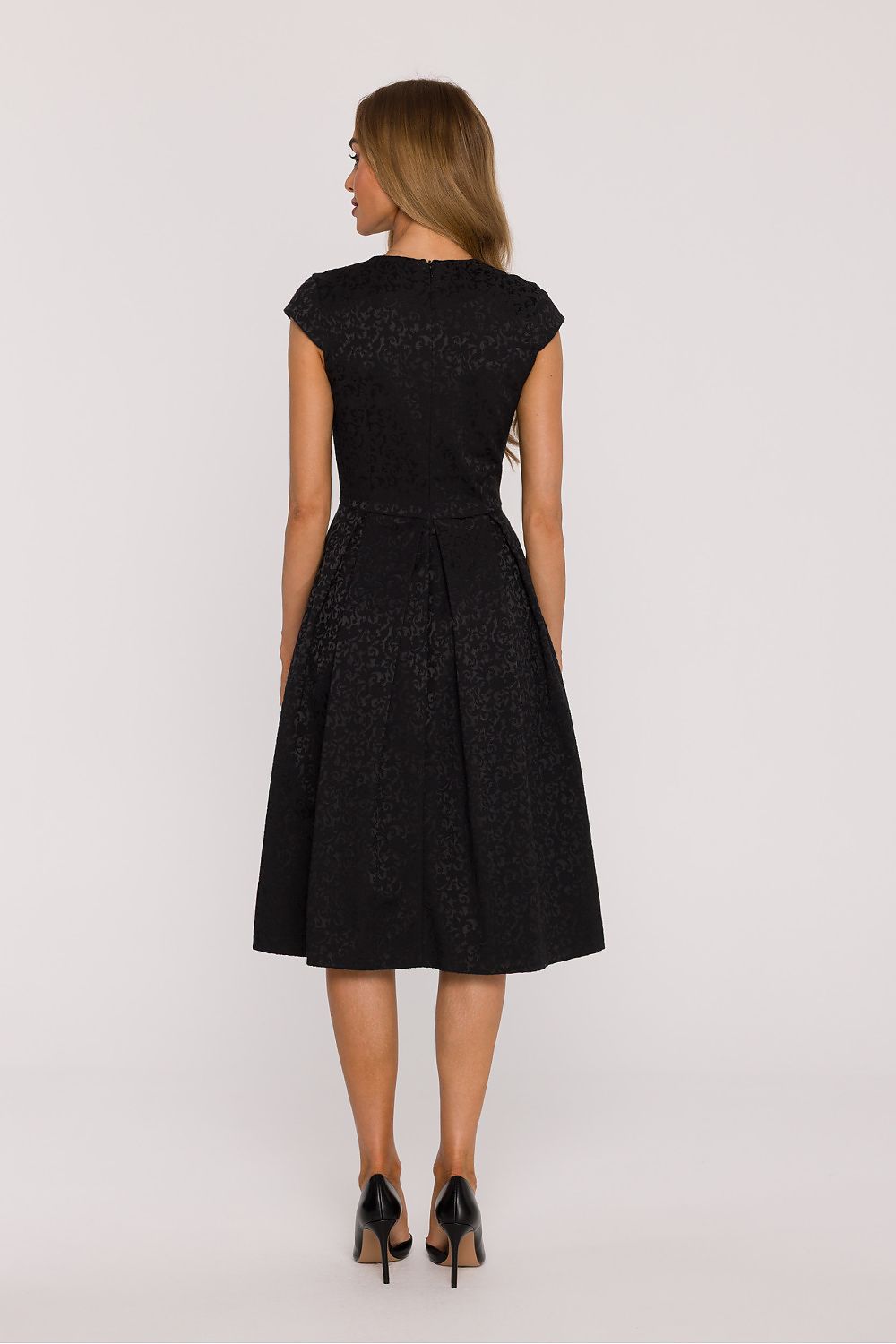 Back view of the Elegant V-Neck Knee-Length Dress by Moe, highlighting the concealed zipper closure and light, airy structure ideal for both everyday wear and elegant events.