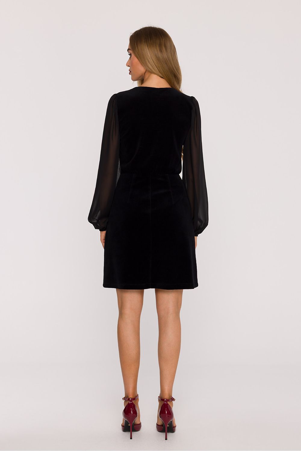 A model wearing the elegant velvet mini dress with chiffon sleeves by Moe, perfect for evening outings and ceremonies.