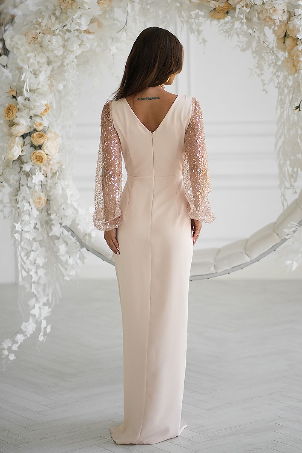 Close-up of Bicotone's stylish long dress featuring intricate sequin detailing on sleeves and a heart-shaped neckline, designed for sizes EU 34 to 48.