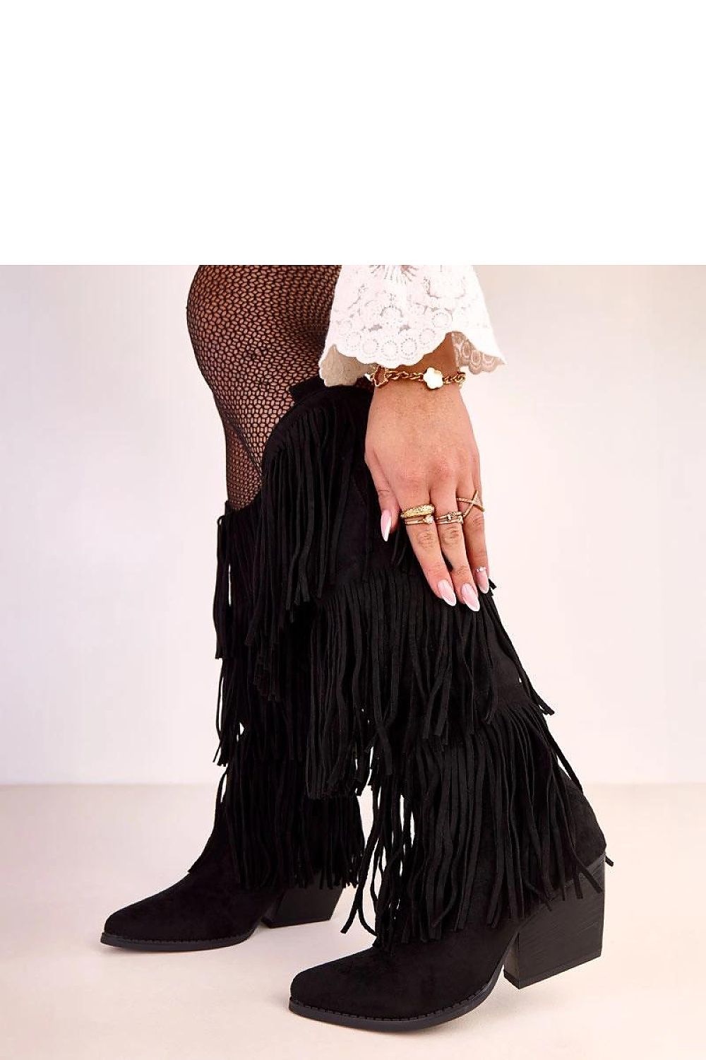 Stylish Solea fringed heel boots in faux suede, exhibiting a captivating design that combines comfort and elegance for versatile outfits.