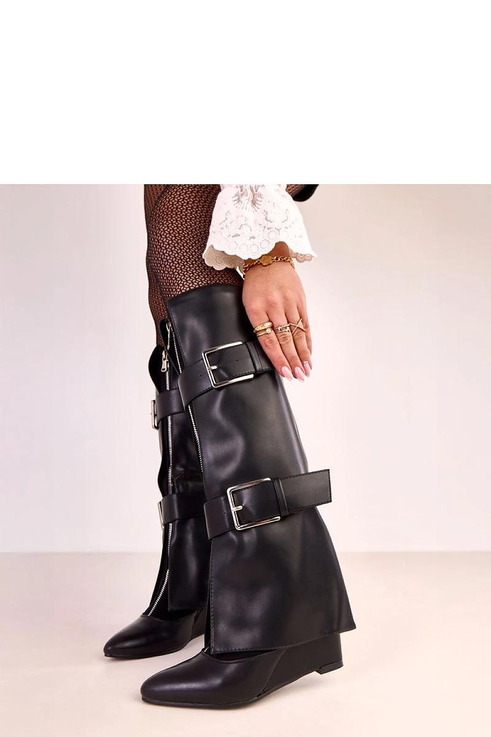 Close-up of Solea chic knee-high buskin boots with luxurious synthetic leather finish, highlighting the fashionable design and comfortable wedge heel.