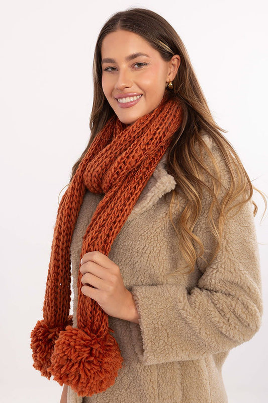 Soft and cozy acrylic shawl with pompons from AT, ideal for wrapping around the neck during cold winter days.