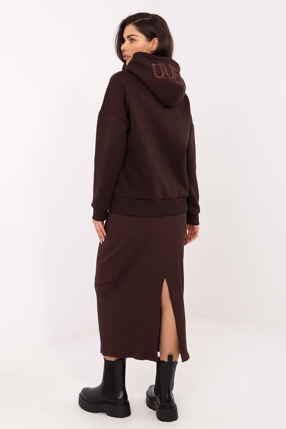 Model wearing the elegant midi-length knitted skirt with slit by Relevance, styled with a casual top, highlighting versatility and effortless chic.