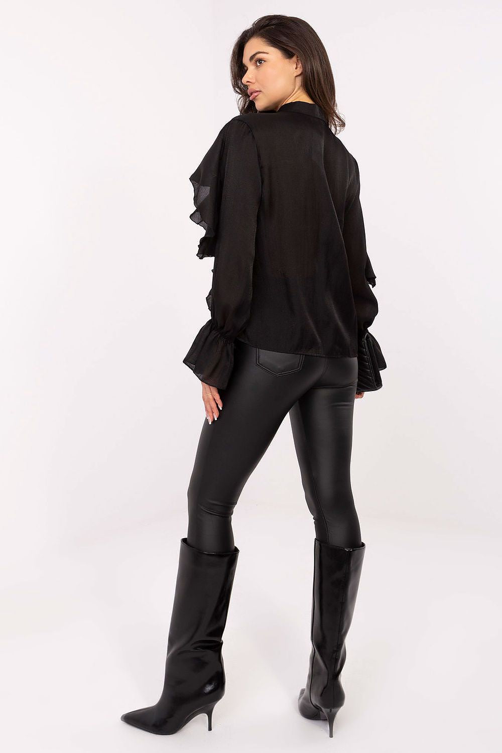 Model wearing Rue Paris's elegant long sleeve shirt with ruffle detail, demonstrating comfortable yet stylish fashion for special occasions.