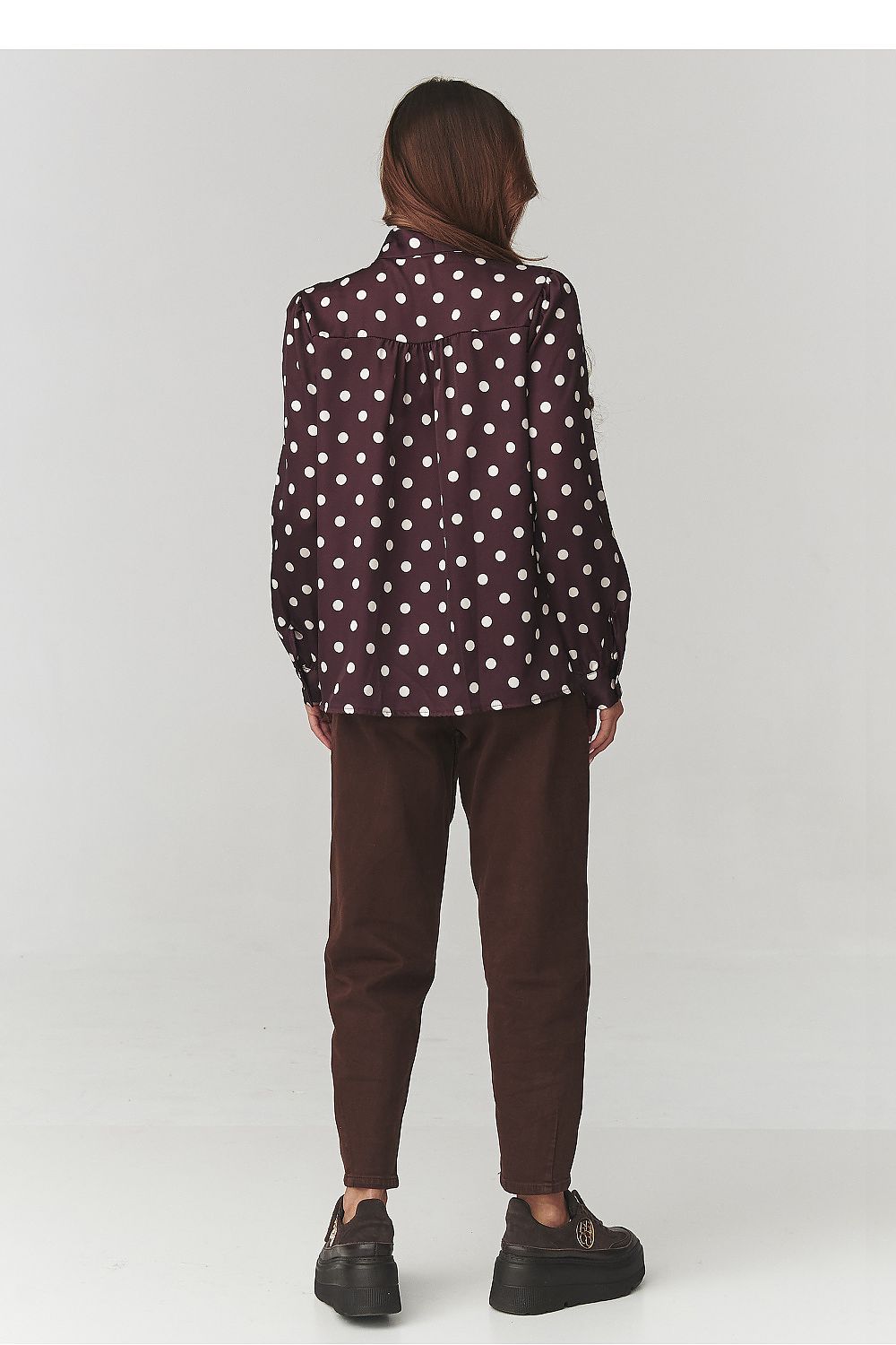 Close-up view of Makadamia's stylish polka dot shirt, showcasing the soft fabric texture and tailored silhouette designed for comfort and elegance.