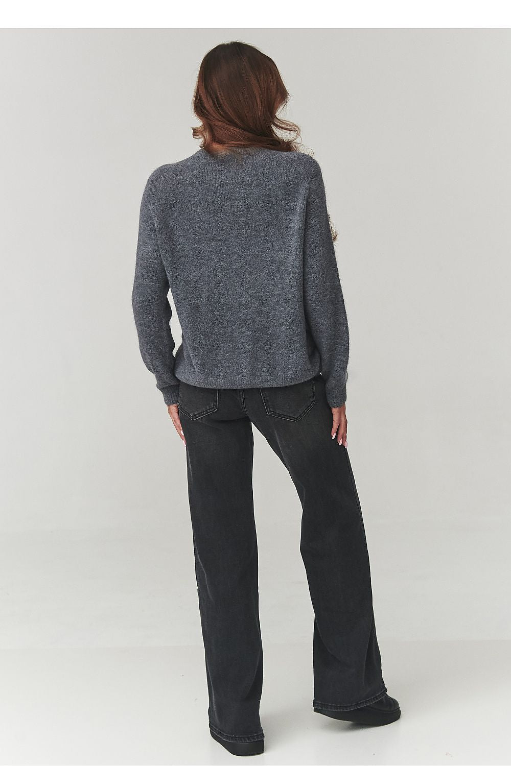 Stylish ensemble featuring Makadamia's elegant women's sweater, beautifully styled with jeans and accessories for a chic, modern look.
