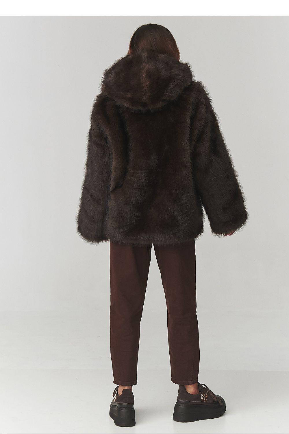 Stylish front view of the Makadamia Luxury Women's Faux Fur Hooded Jacket showcasing its eco-friendly design and spacious hood.