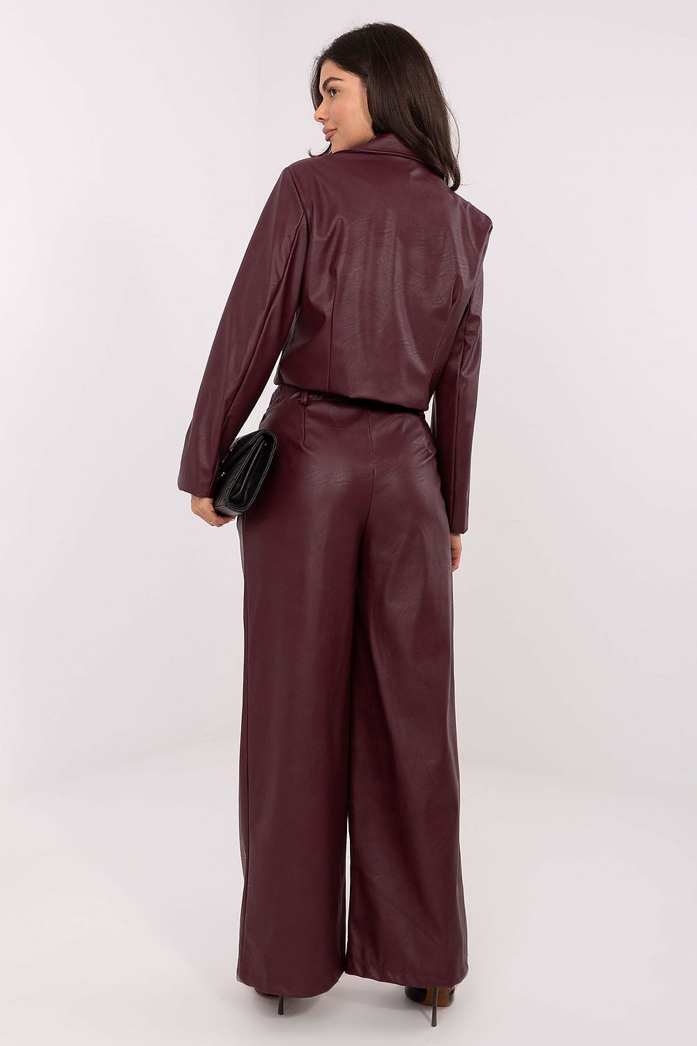 Fashion model wearing stylish high-waisted wide leg eco leather trousers by Rue Paris, exuding luxury and comfort for contemporary women's fashion.