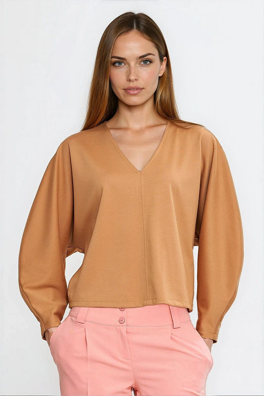 Close-up detailing of Nife oversized blouse showcasing the soft viscose fabric and unique v-neck design, offering refined comfort and style.
