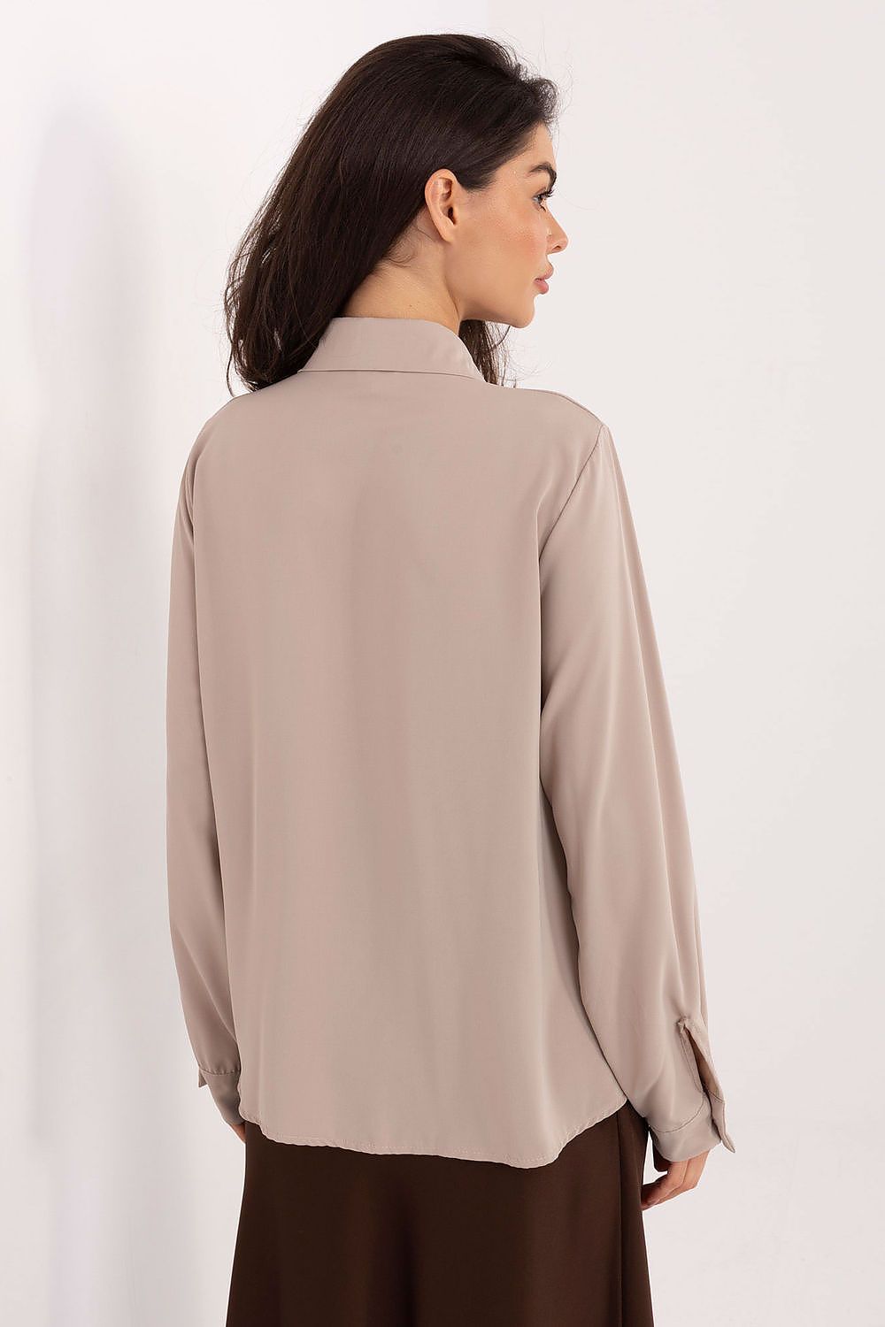 Elegant Women's Long Sleeve Polyester Shirt by Factory Price, perfect for formal and everyday wear, showcasing a timeless design with long puffy sleeves, decorative tying, and a classic collar.