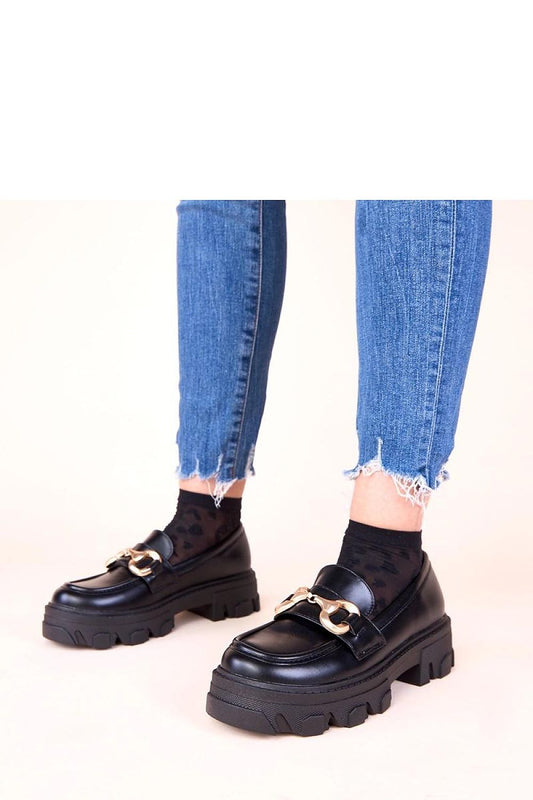 Solea's exquisite black moccasins for women, featuring a stunning gold embellishment, perfect for adding a touch of sophistication to any ensemble.