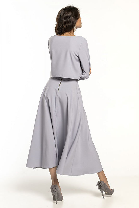 Chic back view of a grey waist-length blouse with 3/4 sleeves, complemented by a graceful skirt, designed for timeless elegance, by Tessita.