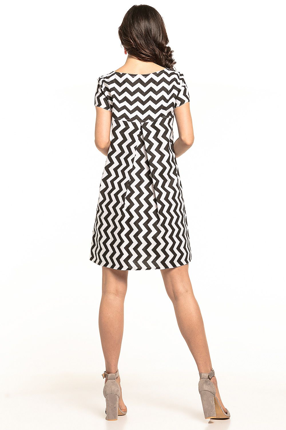 Elegant Tessita mini dress showcasing a stylish boat neckline and playful double ruffle detail at the back. The dress features a chic black and white zigzag pattern, perfect for a sophisticated and girly look. Crafted from 100% cotton, it offers a flattering fit that elegantly embraces movement.