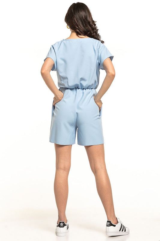 Back view of a luxury light blue summer jumpsuit by Tessita, showcasing its comfortable fit, gathered waist, and smart short design.