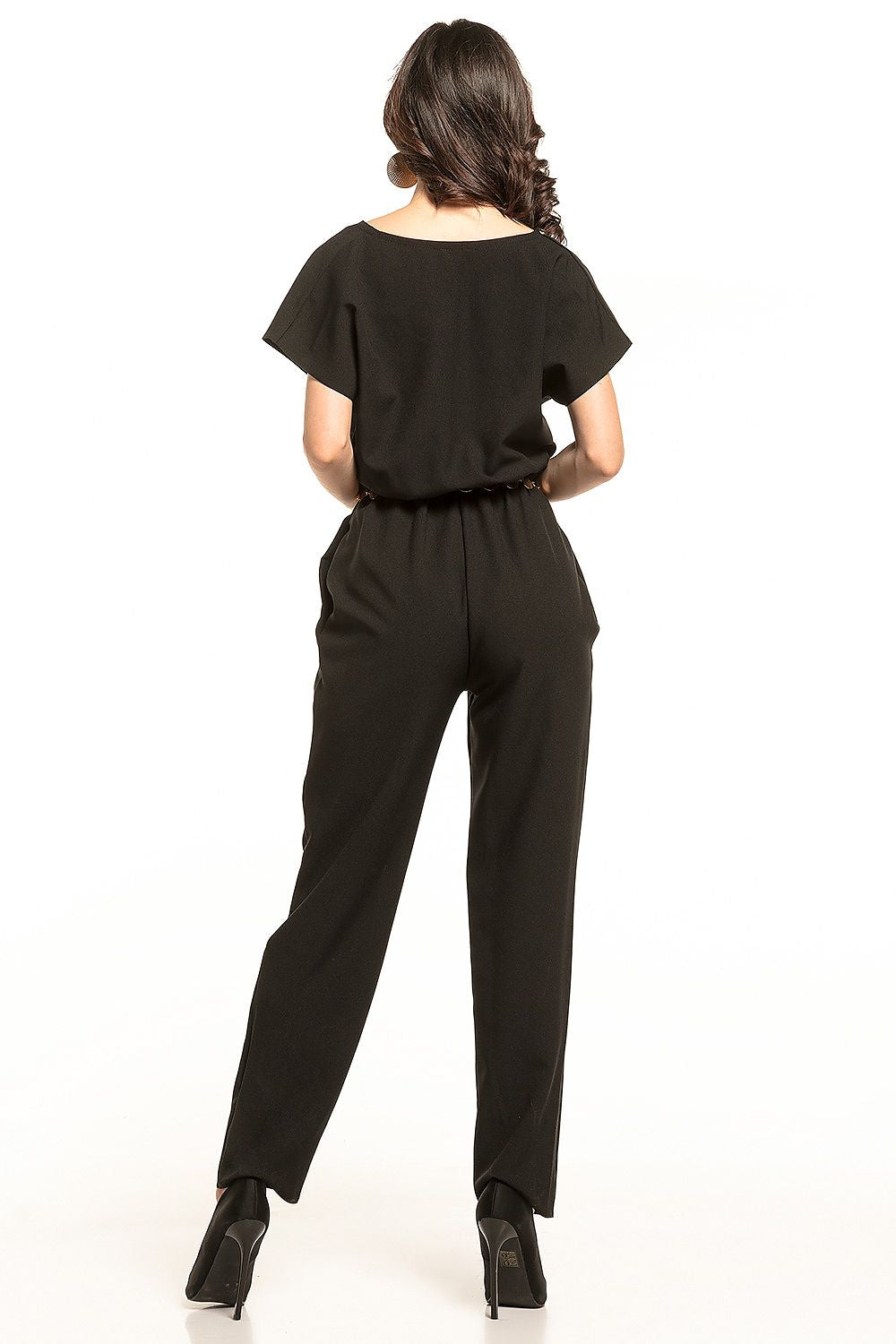 Rear view of the elegant Tessita jumpsuit in black, showcasing the gathered waist and streamlined design. Model captivates with effortless sophistication.