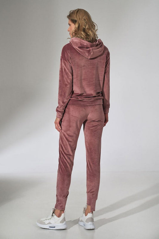 Back view of a woman wearing the Figl Pink Velour Tracksuit Trousers with Tapered Legs and Drawstring Waist, showcasing the soft velour fabric and stylish tapered fit.