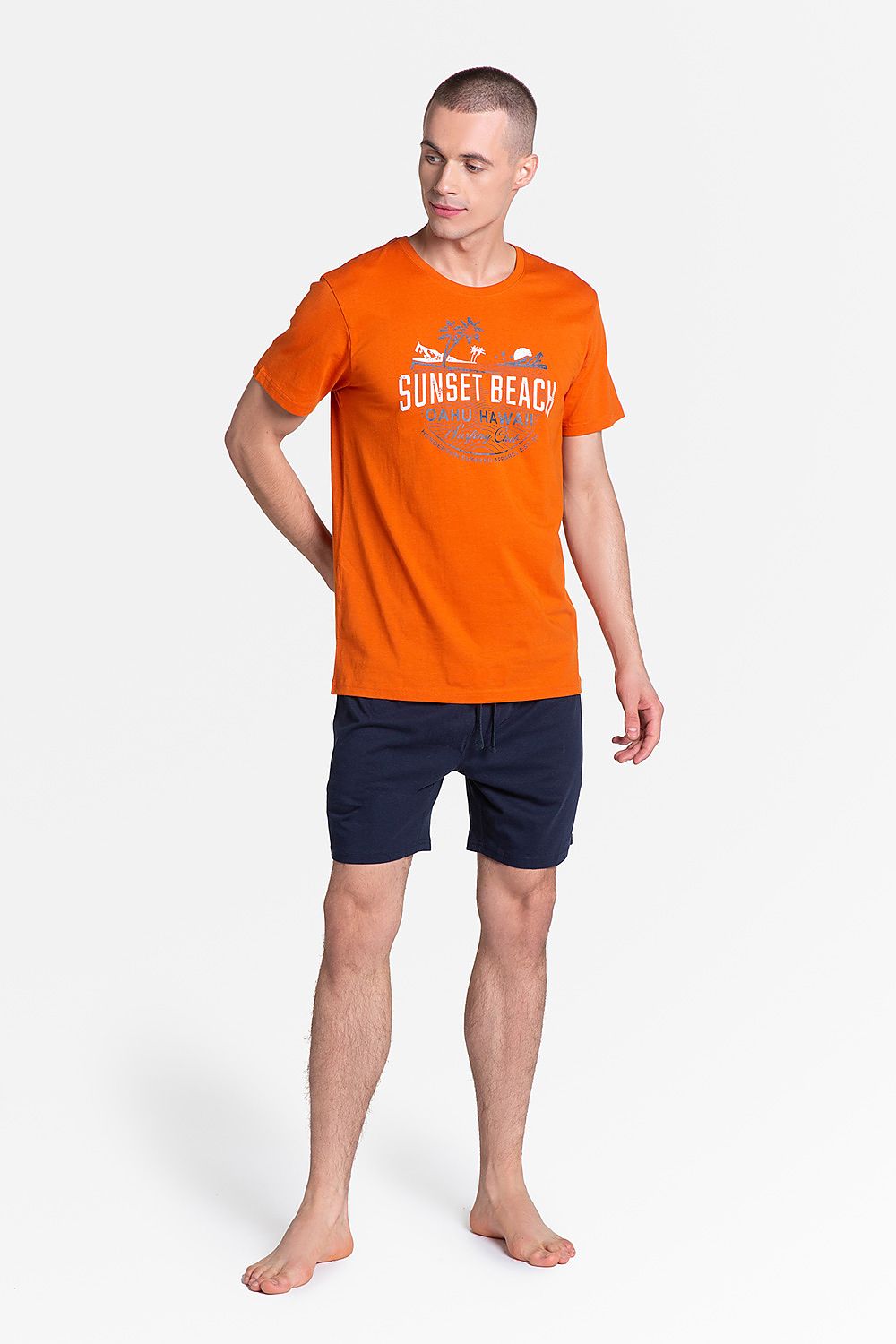 Henderson Cotton Pyjamas Set featuring a stylish orange print T-shirt with 'SUNSET BEACH' design and luxurious navy blue knee-length shorts, perfect for comfortable lounging.