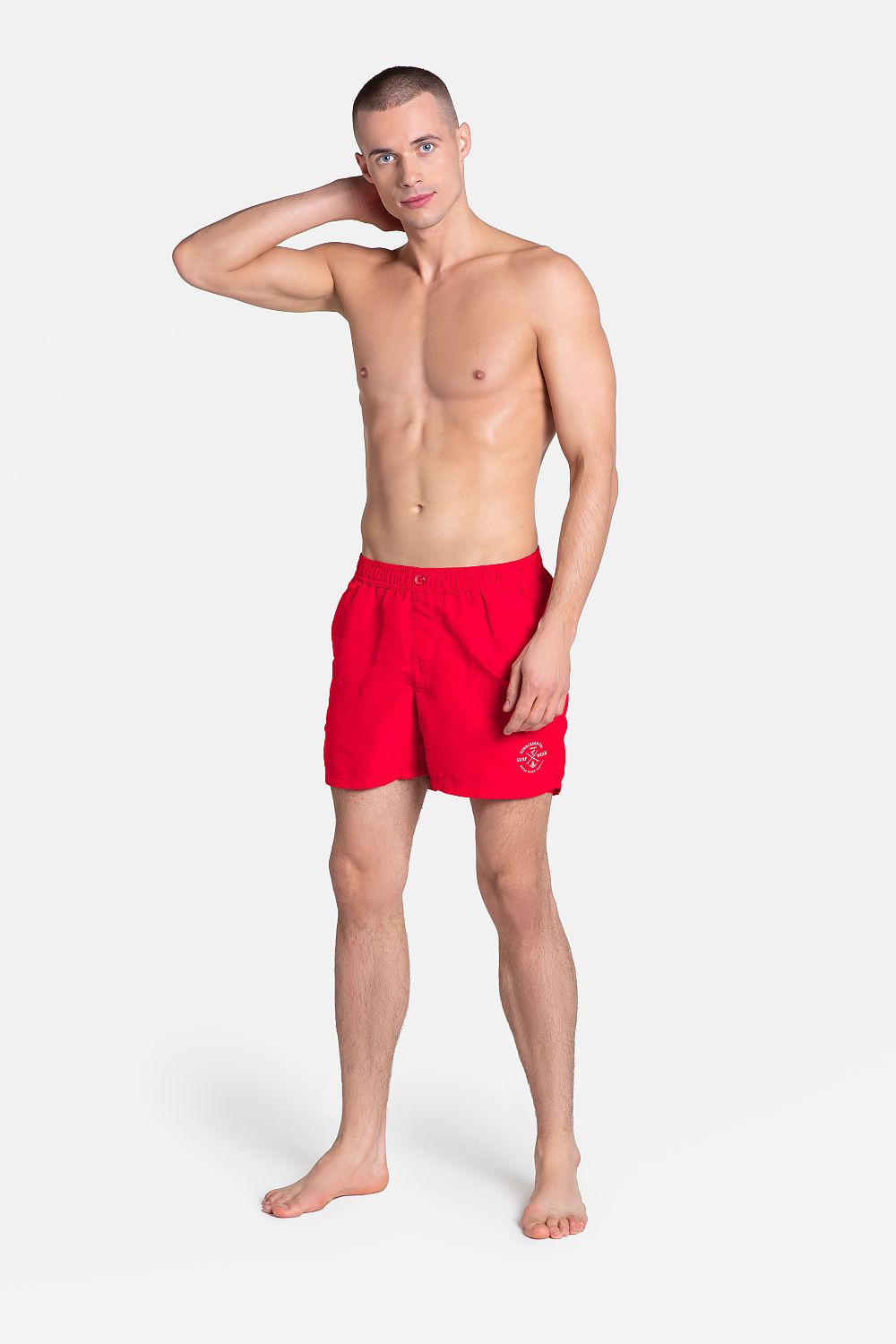 Luxury Henderson 100% Polyester Sporty Swim Trunks with Applique, featuring a comfortable loose-fit beachwear design, modeled by a stylish man in red swim shorts.