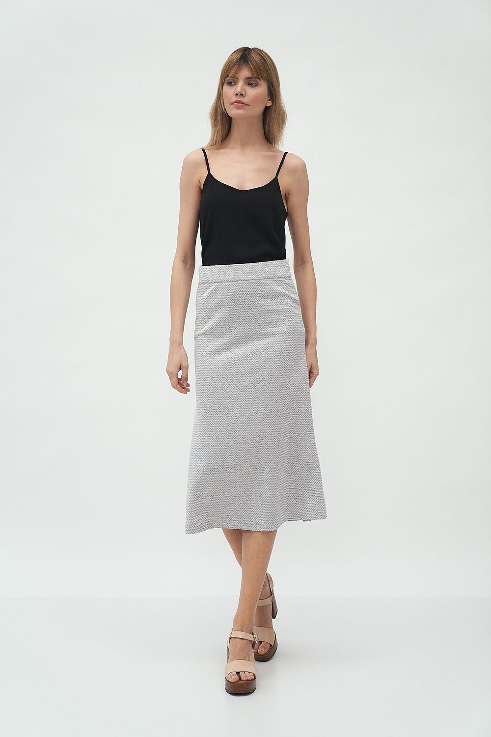 Luxury Midi Skirt by Nife on a model, presenting the timeless flared silhouette in textured knitwear, ideal for effortless spring elegance.