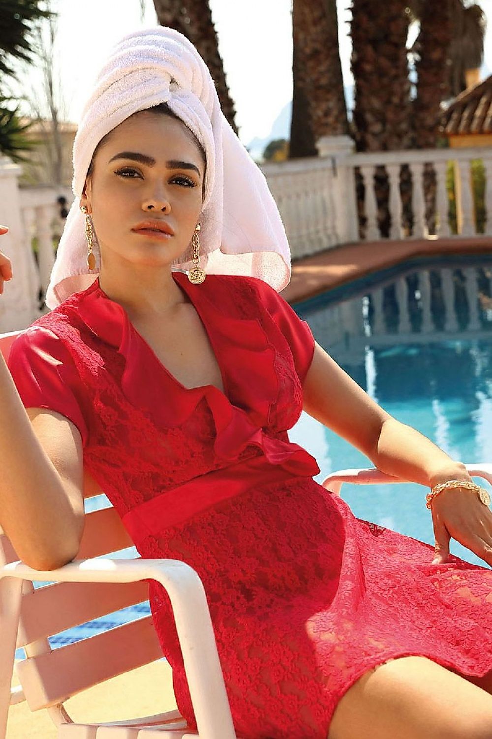 Chic red DKaren lace dressing gown, paired with a towel on the head, exuding glamour and allure by the pool, ideal for a luxe summer retreat.