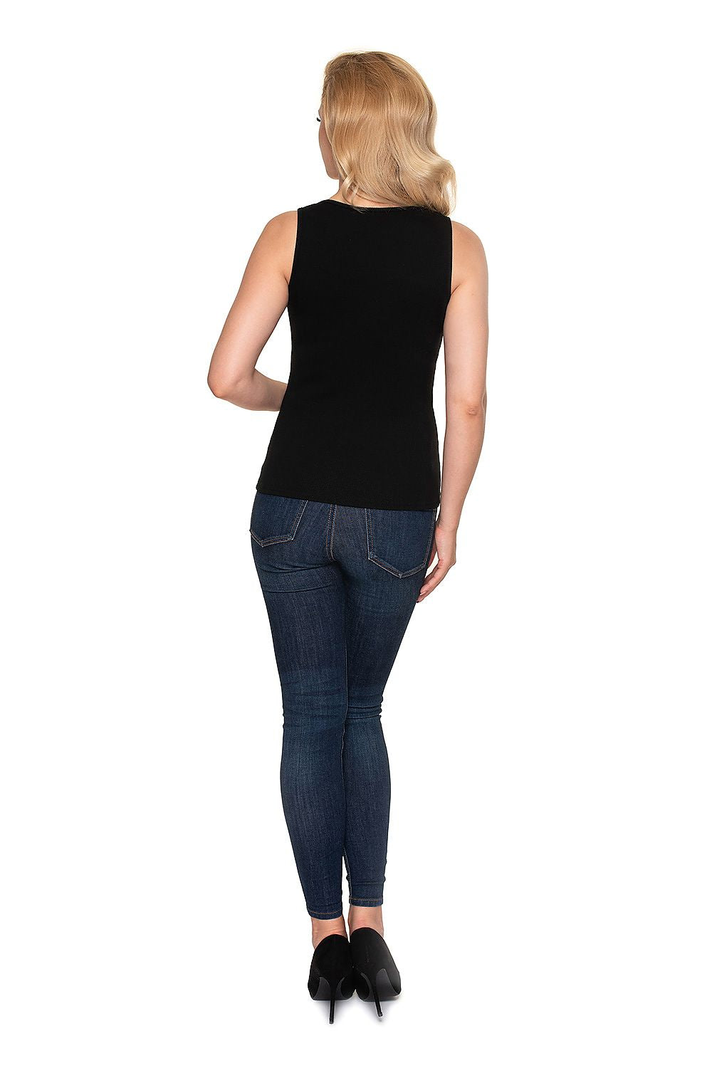 Model displaying the back side of a luxury fitted blouse with heart neckline in black ribbed cotton by PeeKaBoo, styled effortlessly with dark denim.