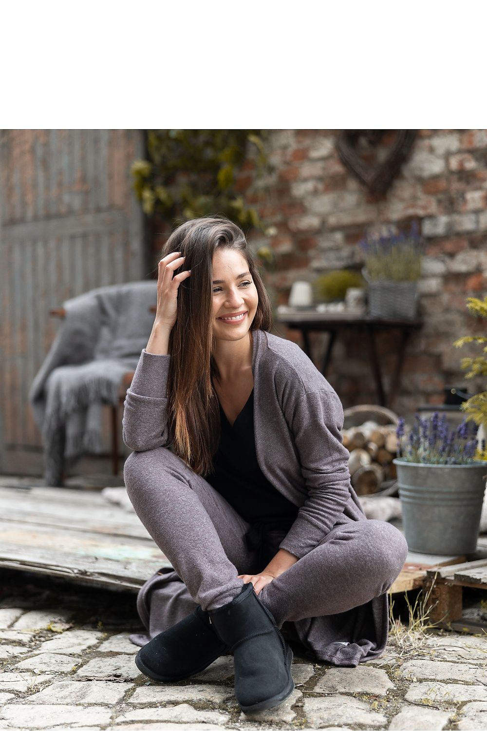 Luxury Brown Viscose Knitwear Cardigan with Pockets – Longer Style by Sensis, model lounging comfortably, smiling while wearing the cardigan paired with stylish lounge trousers.