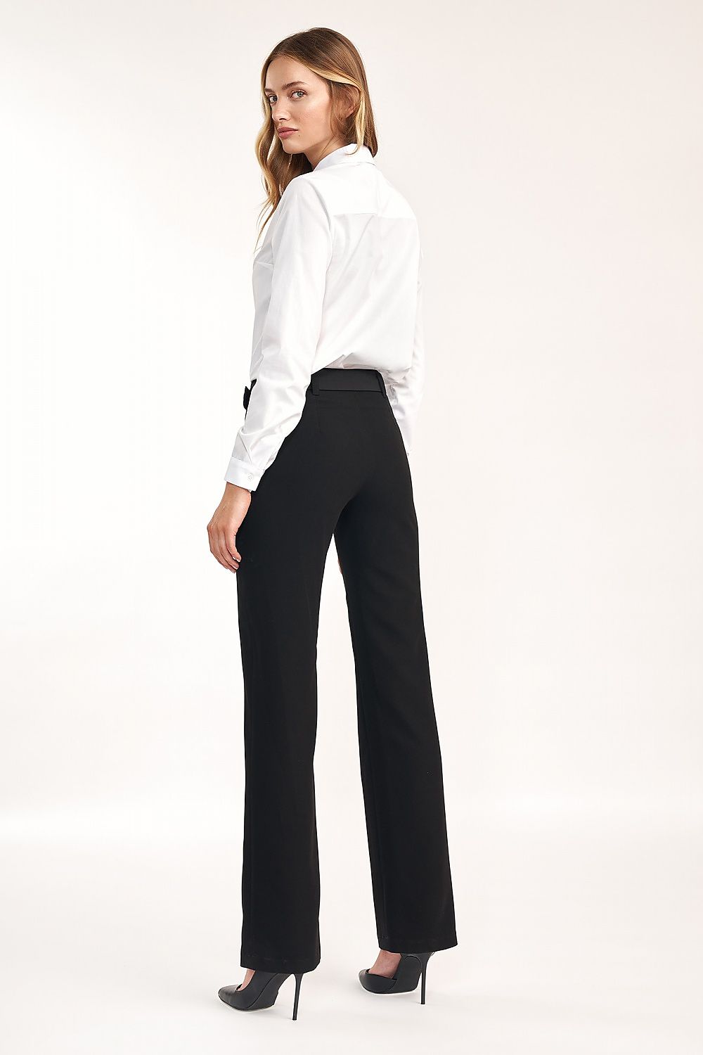 Another angle of the Elegant Long Sleeve Slim-Fit White Shirt by Nife styled with elegant black pants, featuring a sophisticated look for versatile occasions.