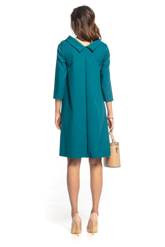Back view of the elegant Tessita midi dress with 3/4 sleeves and folded collar, showcased in a luxurious teal fabric, perfect for sophisticated occasions.