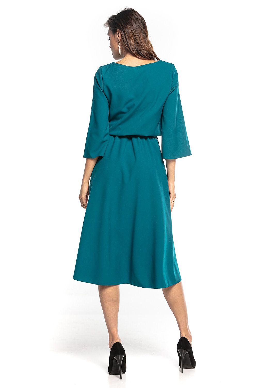 Back view of the elegant asymmetrical midi dress by Tessita, featuring a longer back and cinched waist, offering a luxurious silhouette in a vibrant turquoise colour.