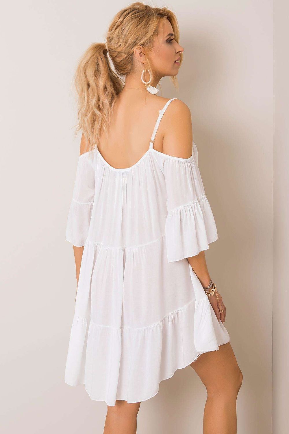 Back view of a luxurious white summer dress, showcasing its flowy design, off-the-shoulder sleeves, and delicate frills, ideal for a stylish summer outing.