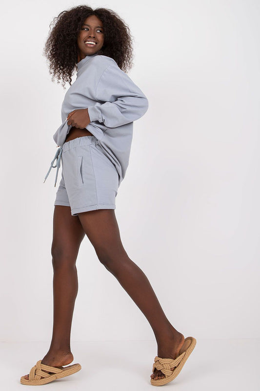 Chic summer look showcasing BFG men's luxury cotton sweatshorts in pastel blue, with a relaxed fit and side pockets for effortless style.