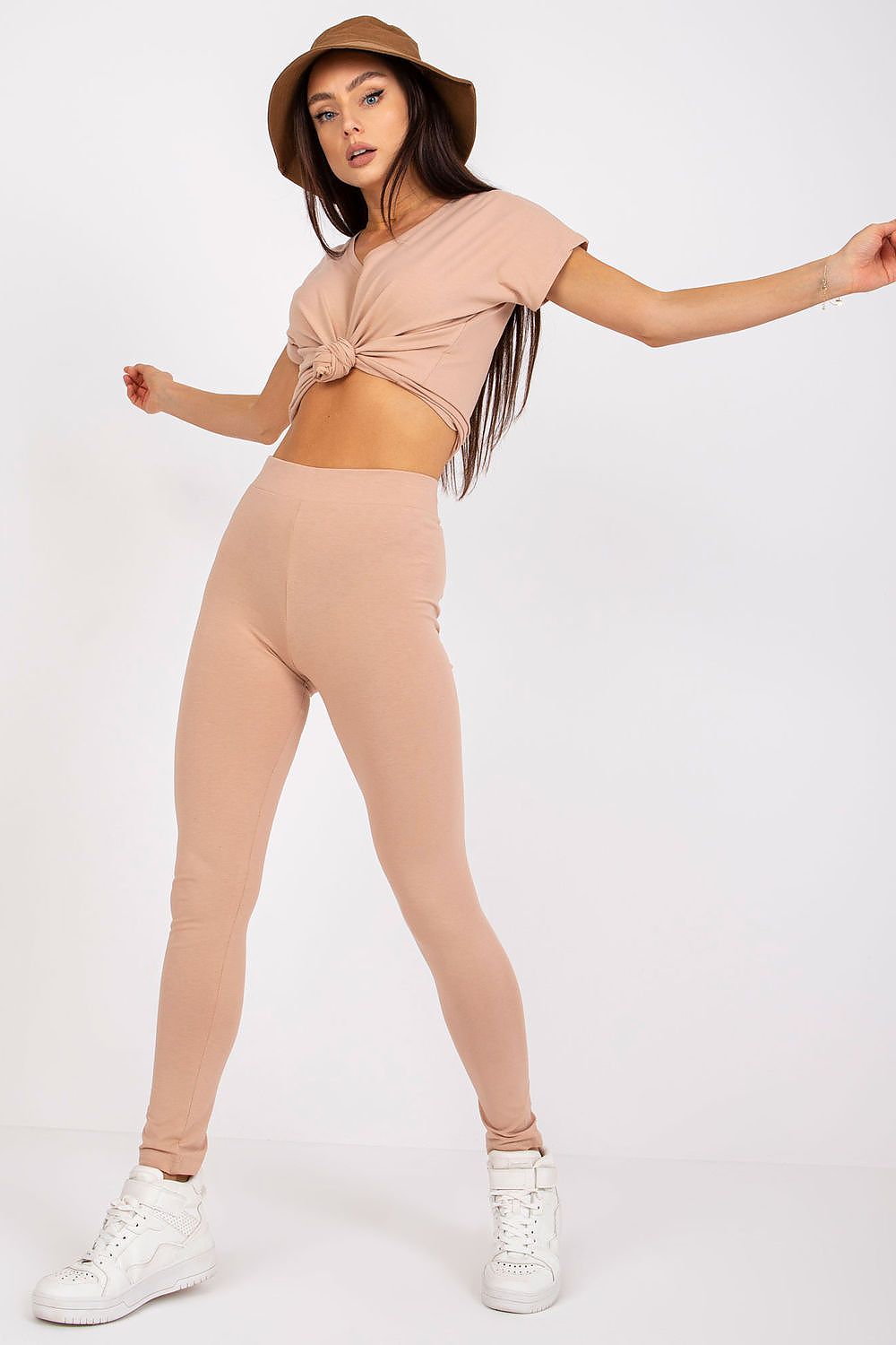Confident model in attractive nude BFG Luxury Cotton-Spandex Leggings and knotted top, demonstrating a perfect blend of comfort and elegance.