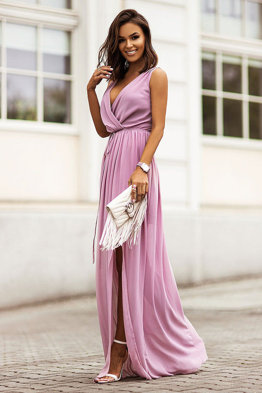 Dolores Chiffon Maxi Dress by IVON - Stunning side view of a model in a light pink maxi dress featuring an adjustable waist, ideal for summer outings.