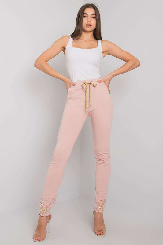 Luxury High Rise Sweatpants with Rhinestone Cuffs and Tie Waist - Cotton Spandex Blend, featuring a model in a pink outfit striking a pose, highlighting the elegant design and gold tie of the sweatpants.