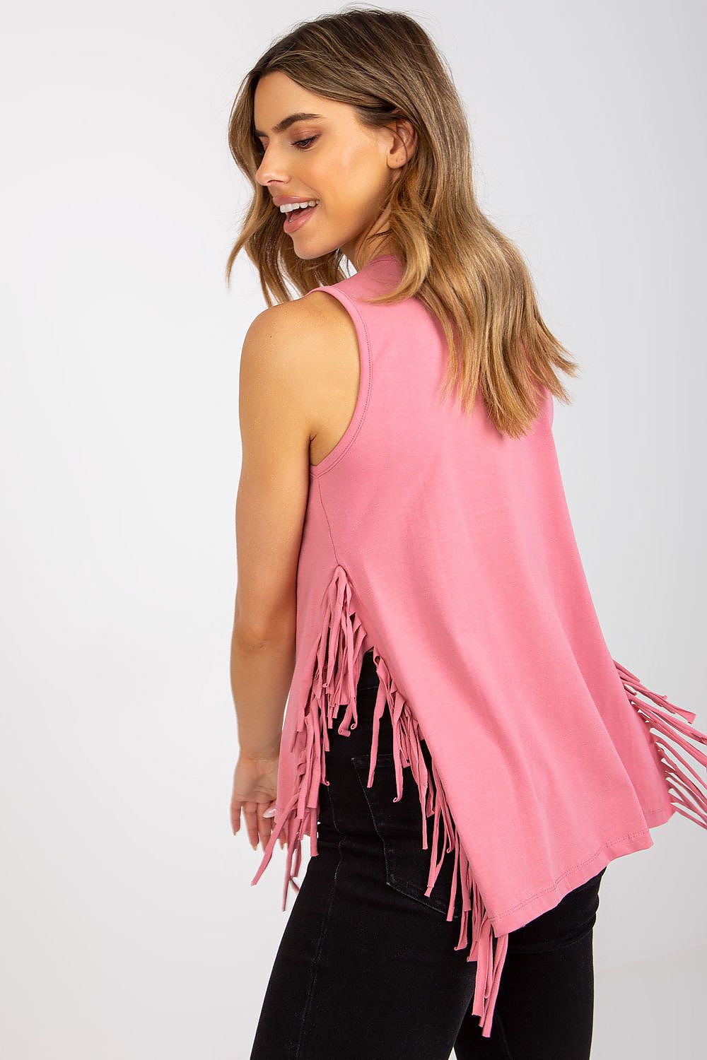 Elegant Sleeveless Summer T-Shirt with Heart Neckline and Decorative Tassels captured on model from behind, showcasing the flowing back and beautiful tassel accents.