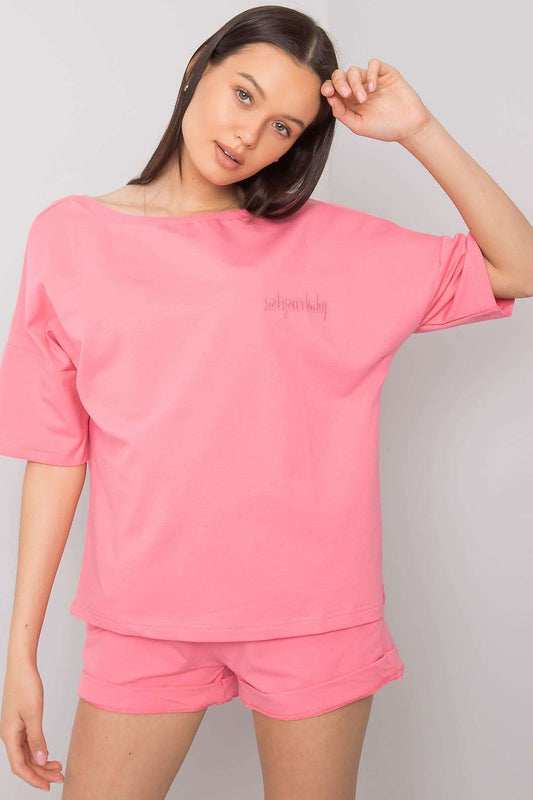 Elegant Cotton Blouse And Shorts Set With Elastic Waistband And Slip-On Pockets showcased by a model in a relaxed pose, highlighting the stylish pink set.