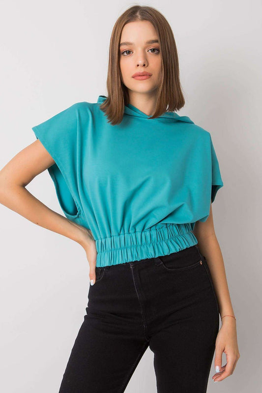 Elegant image of a Ladies' Loose-Fit Sweatshirt with Short Sleeves and Hood, 65% Cotton Blend, in a vibrant turquoise colour, highlighting its chic and modern style worn by a model.