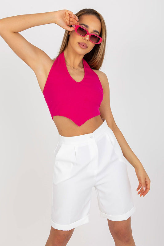 Stylish model showcasing the Ribbed Cotton Spandex Summer Top by Rue Paris, featuring a trendy halter neck design in vibrant fuchsia, paired with tailored white shorts.