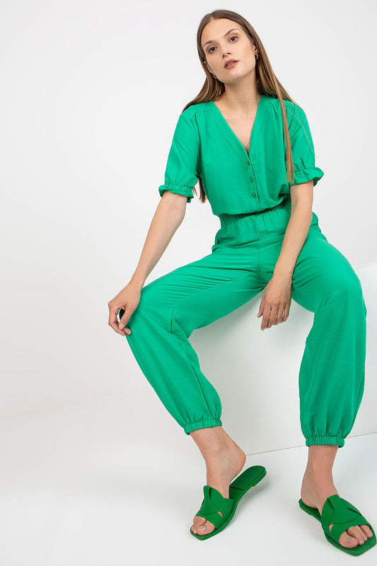 Rue Paris Summer Cotton Jumpsuit with Frill Sleeves and Side Pockets - An elegant shot of a model in a vibrant green jumpsuit, featuring a flattering elastic waist and chic side pockets.