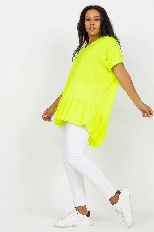 Elegant Plus Size Asymmetrical Tunic with Heart Neckline and Frill, Short Sleeves, featured in an eye-catching neon yellow, paired with chic white jeans and stylish sneakers, representing modern luxury in plus size clothing.