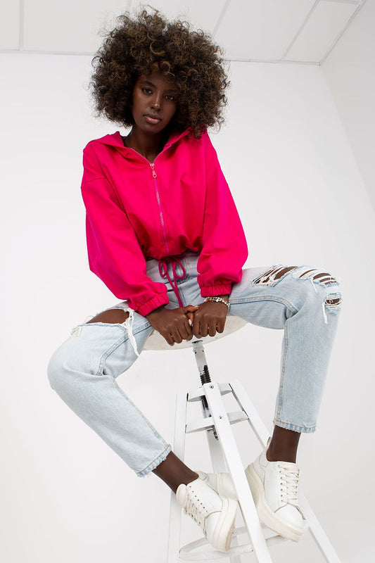 Luxury Women’s Hooded Zippered Sweatshirt by Rue Paris, featuring a vibrant fuchsia colour, styled with ripped light blue jeans and white sneakers, perfect for chic and casual looks.