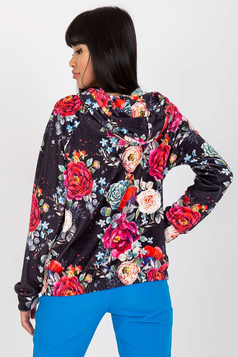 Luxurious Rue Paris Women's Hooded Zip Sweatshirt with Pockets showcased in a floral design, featuring vibrant roses on a dark background, worn by a model with long hair, exuding elegance and comfort in sizes S/M & L/XL.