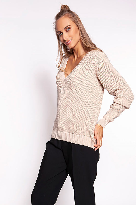 Luxurious Minimalist Ribbed Knit Jumper with Deep Heart Neckline by MKM, side view of the beige sweater worn with tailored black trousers, emphasizing its sophisticated design.