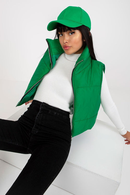 The luxurious Och Bella Women's Insulated Quilted Vest - Short Zippered Nylon Gilet in a striking green hue, elegantly worn over a white top against a minimalist background, designed for sophisticated outdoor wear.