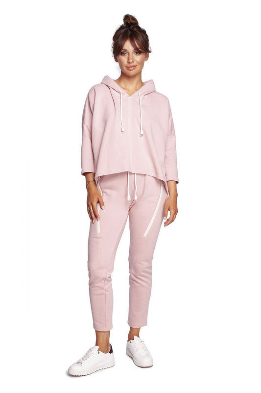 BeWear Loose-Fitting Trapeze Sweatshirt in Soft Knit with Hood and Faux Leather Accents, paired with sleek pink joggers for a luxurious athleisure ensemble.