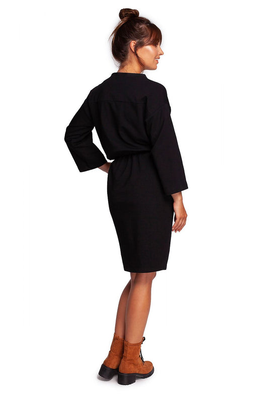 Elegant BeWear Daydress with Teardrop Neckline and Sporty Accents in Soft Knit Fabric, featuring the model from behind in a sleek black dress with a relaxed fit and knot detail at the waist, ideal for chic everyday wear.