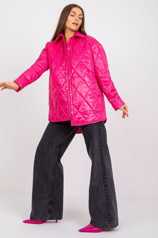 Elegant Women's Quilted Jacket by Rue Paris, displayed in a striking pink colour, detailed with a diamond quilted pattern, complemented by stylish black wide-leg jeans, exuding sophistication for the transitional season.
