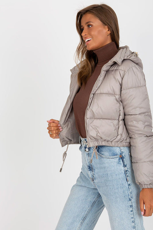 Side view of Luxury Women's Down Quilted Jacket with Detachable Hood and Zippered Pockets, highlighting its trendy design and luxurious fabric, paired effortlessly with a stylish turtleneck.