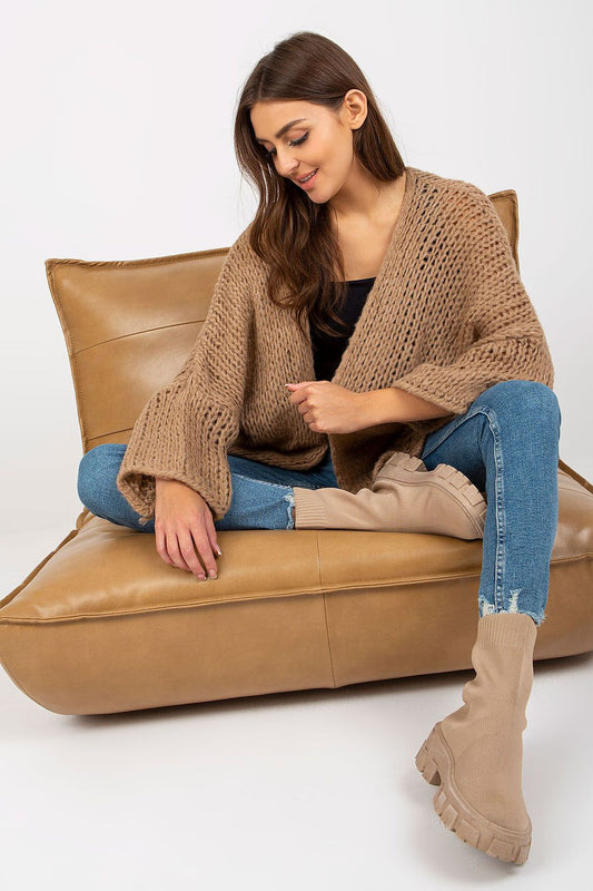 Luxury Women's Long Sleeve Cardigan by Och Bella - Soft Acrylic Blend, Elegant Design. The model elegantly poses in a fashionable beige cardigan paired with fitted jeans, highlighting the cardigan’s unique texture and laid-back sophistication.